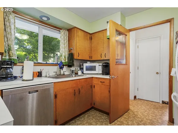 a kitchen with lots of counter top space and windows