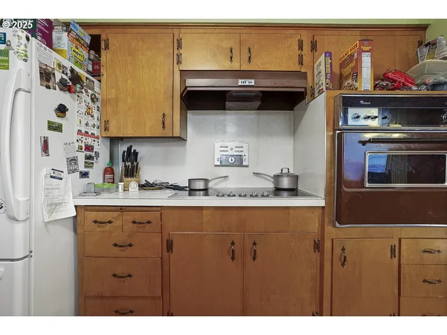 a kitchen with stainless steel appliances granite countertop a sink and cabinets