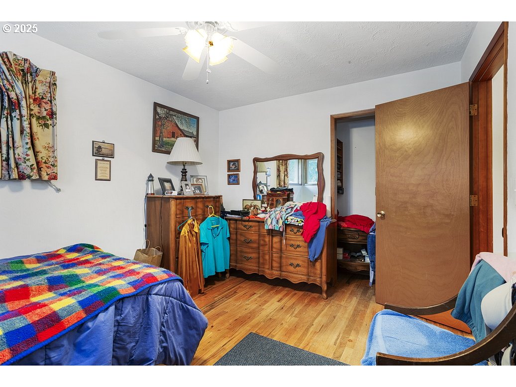 205 Northeast 160th Avenue Portland, OR 97230 - Photo 24 of 35 a bedroom with furniture and a wooden floor