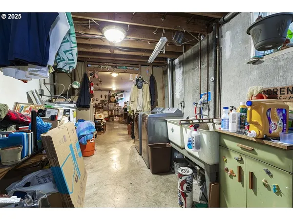 a view of a backyard with table and chairs potted plants and wooden fence