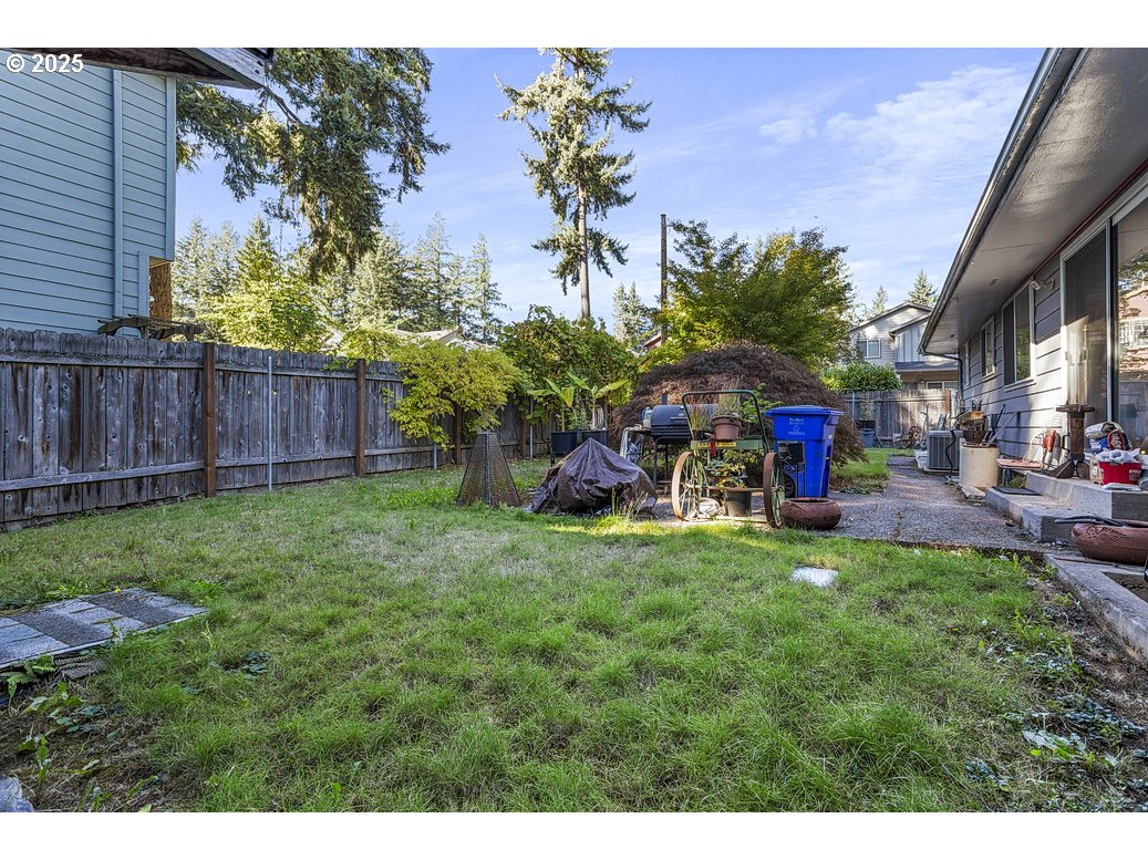 205 Northeast 160th Avenue Portland, OR 97230 - Photo 32 of 35 a view of a backyard with table and chairs potted plants and wooden fence