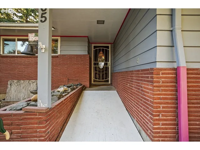 a picture of a living room with a fireplace furniture and a large window