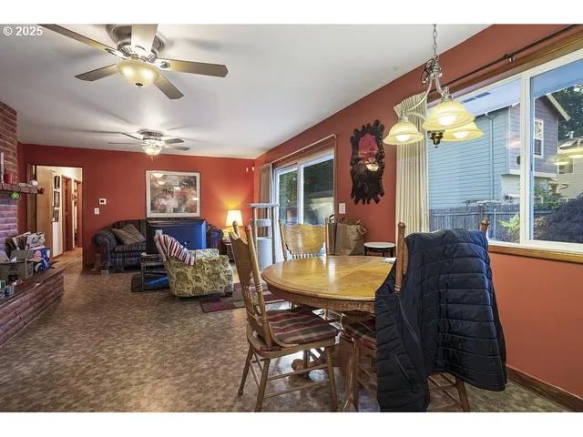 a view of a dining room with furniture and a chandelier