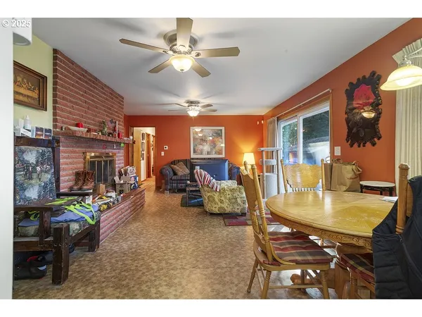 a view of a dining room with furniture a kitchen and chandelier