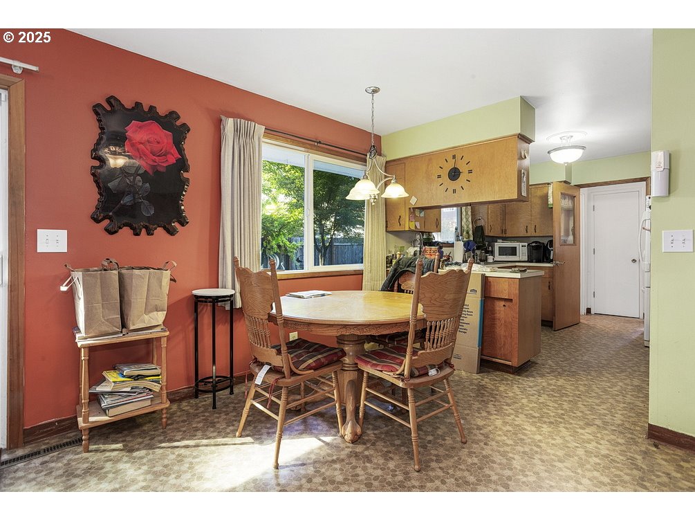 205 Northeast 160th Avenue Portland, OR 97230 - Photo 9 of 35 a view of a dining room with furniture a kitchen and chandelier