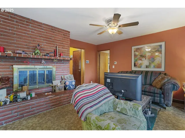 a very nice looking living room with furniture a fireplace and a large window