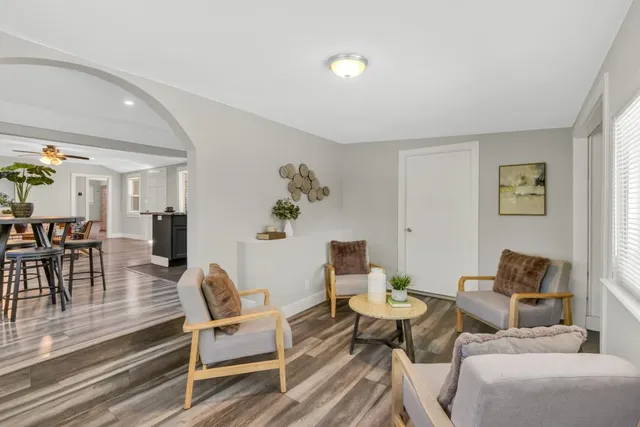 a living room with furniture and wooden floor