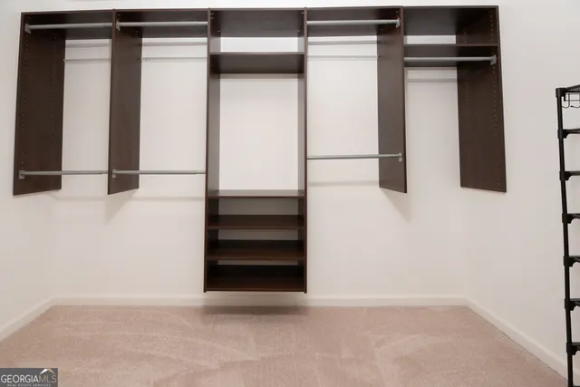 a bathroom with a granite countertop sink a toilet a mirror and shower