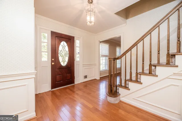 a view of an entryway with wooden floor