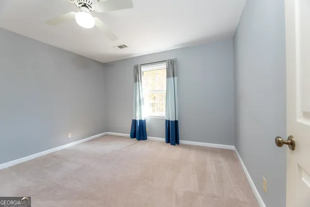 a bathroom with a granite countertop toilet sink and mirror