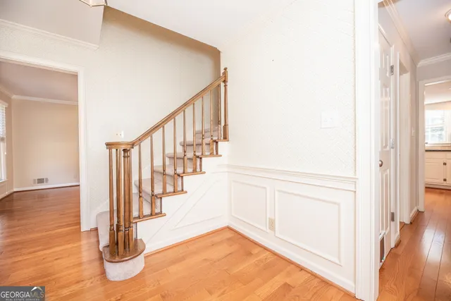 a view of entryway and hall with wooden floor
