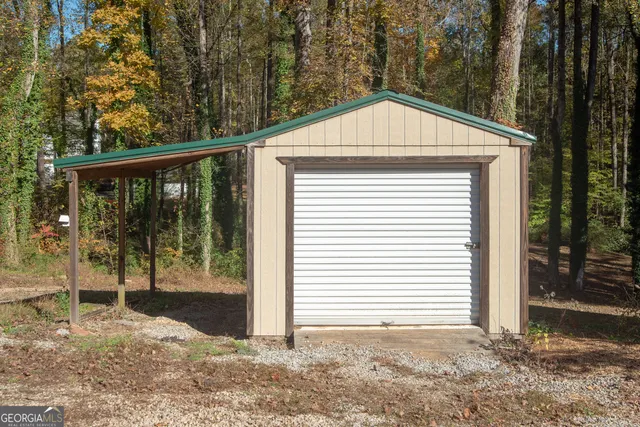 a white house that has a tree in front of it