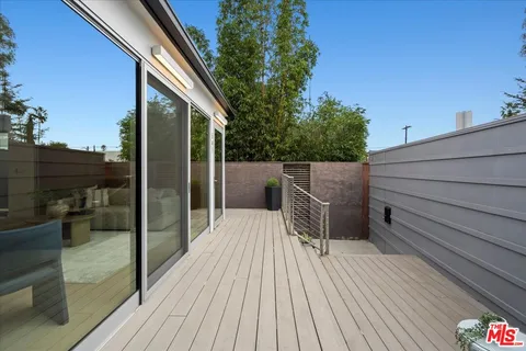 a view of a wooden deck and a backyard