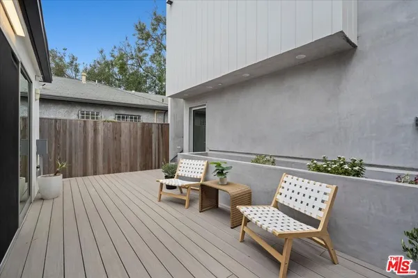 a balcony with furniture and wooden floor