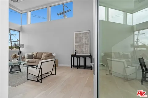 a living room with furniture a flat screen tv and a table