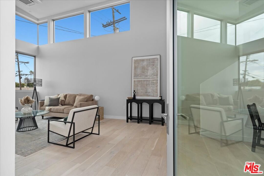 541 Rose Avenue, Unit LOFT Venice, CA 90291 - Photo 6 of 13 a living room with furniture a flat screen tv and a table