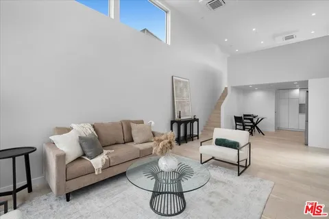 a living room with furniture a rug and a chandelier