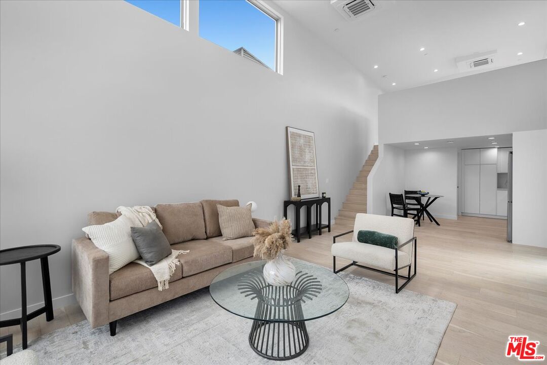 541 Rose Avenue, Unit LOFT Venice, CA 90291 - Photo 7 of 13 a living room with furniture a rug and a chandelier