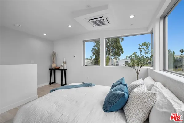 a bed room with a bed and a large window