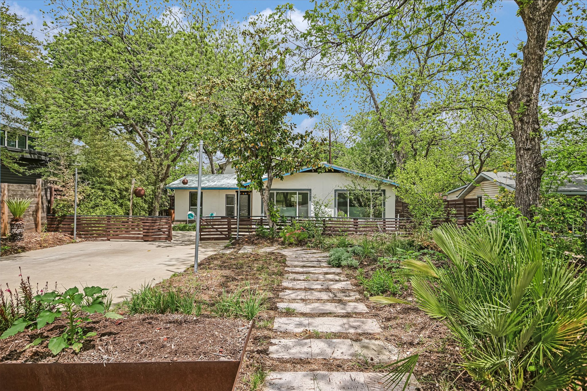 504 Powell Circle Austin, TX 78704 - Photo 2 of 23 a front view of a house with a garden