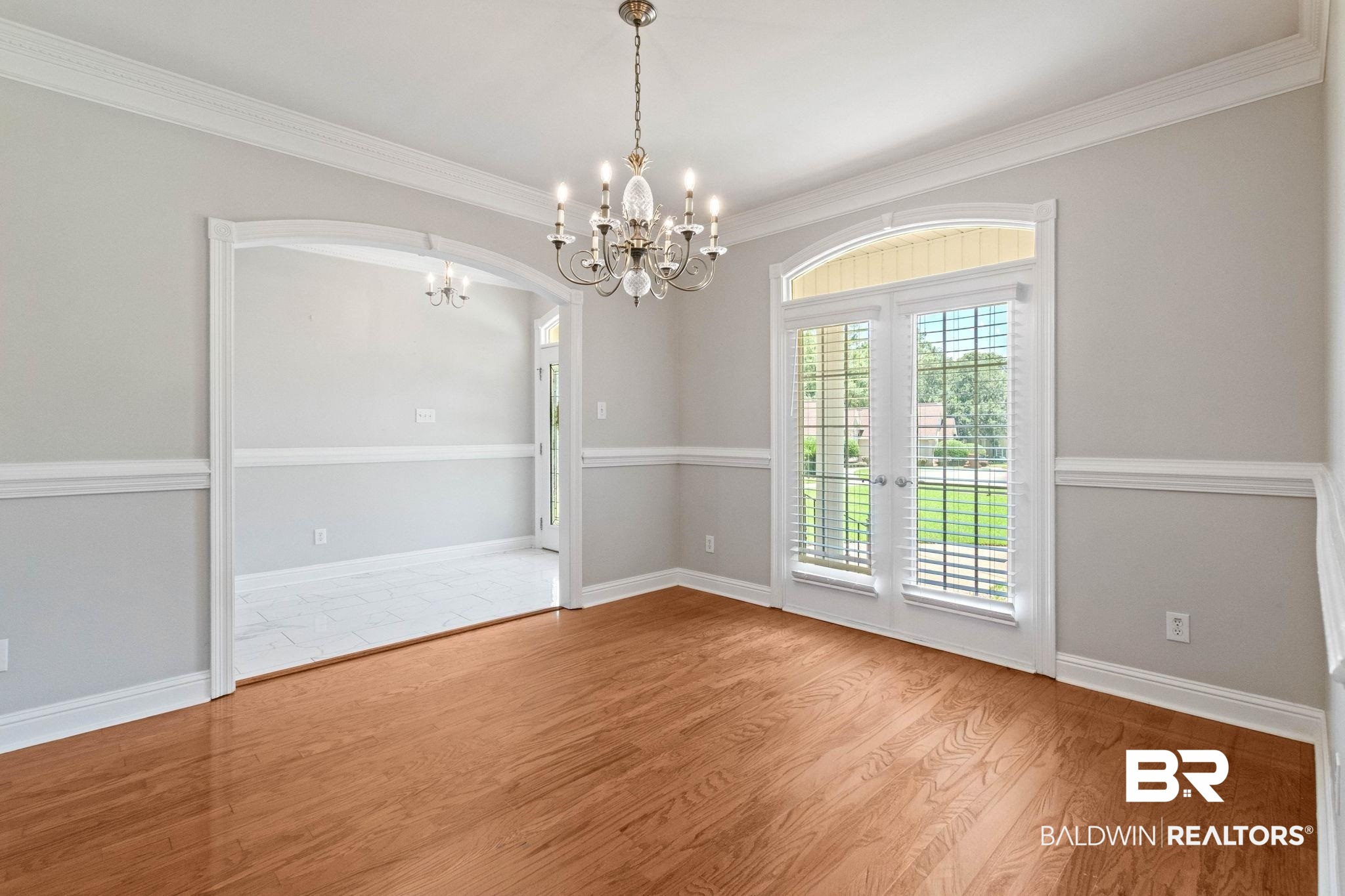 3176 Cedar Court Mobile, AL 36619 - Photo 8 of 33 Hardwood-finish flooring and an elegant chandelier highlight this room