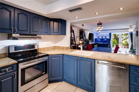 a kitchen with wooden cabinets and a stove top oven