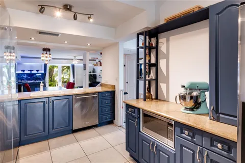 a kitchen with stainless steel appliances granite countertop a sink and cabinets