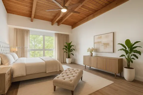 a bedroom with a large bed and a window