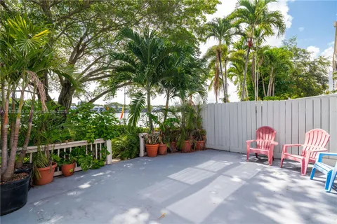 a backyard of a house with barbeque oven and outdoor seating