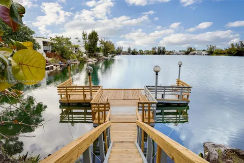 a view of a lake with wooden bridge