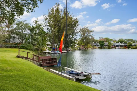 a small pool with lawn chairs and a table