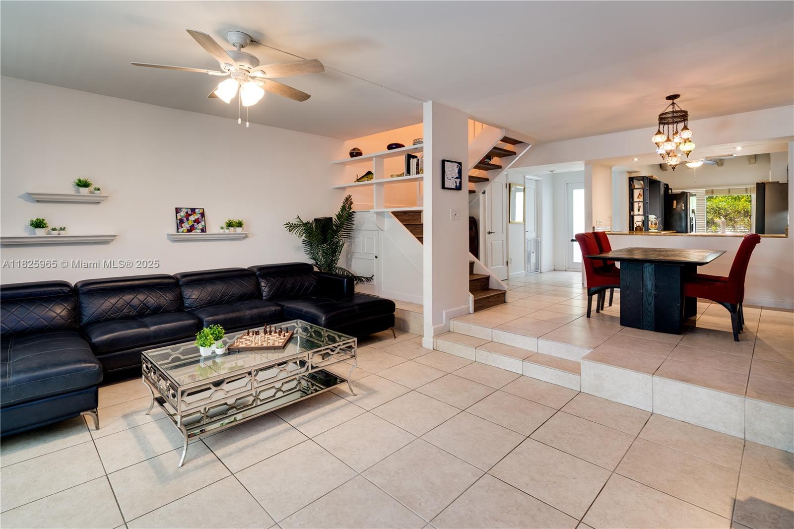 5292 Southwest 69th Place Miami, FL 33155 - Photo 8 of 37 a living room with furniture a dining table and paintings on the wall