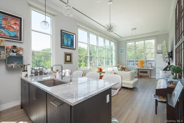 a view of living room with furniture large window and wooden floor