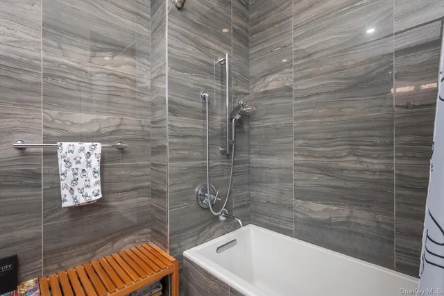 a bathroom with a bathtub and shower