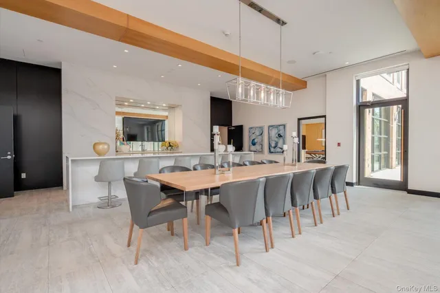a dining room with a table chairs and a kitchen view