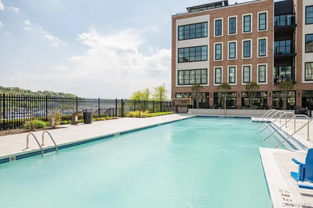 a view of swimming pool with outdoor seating and city view