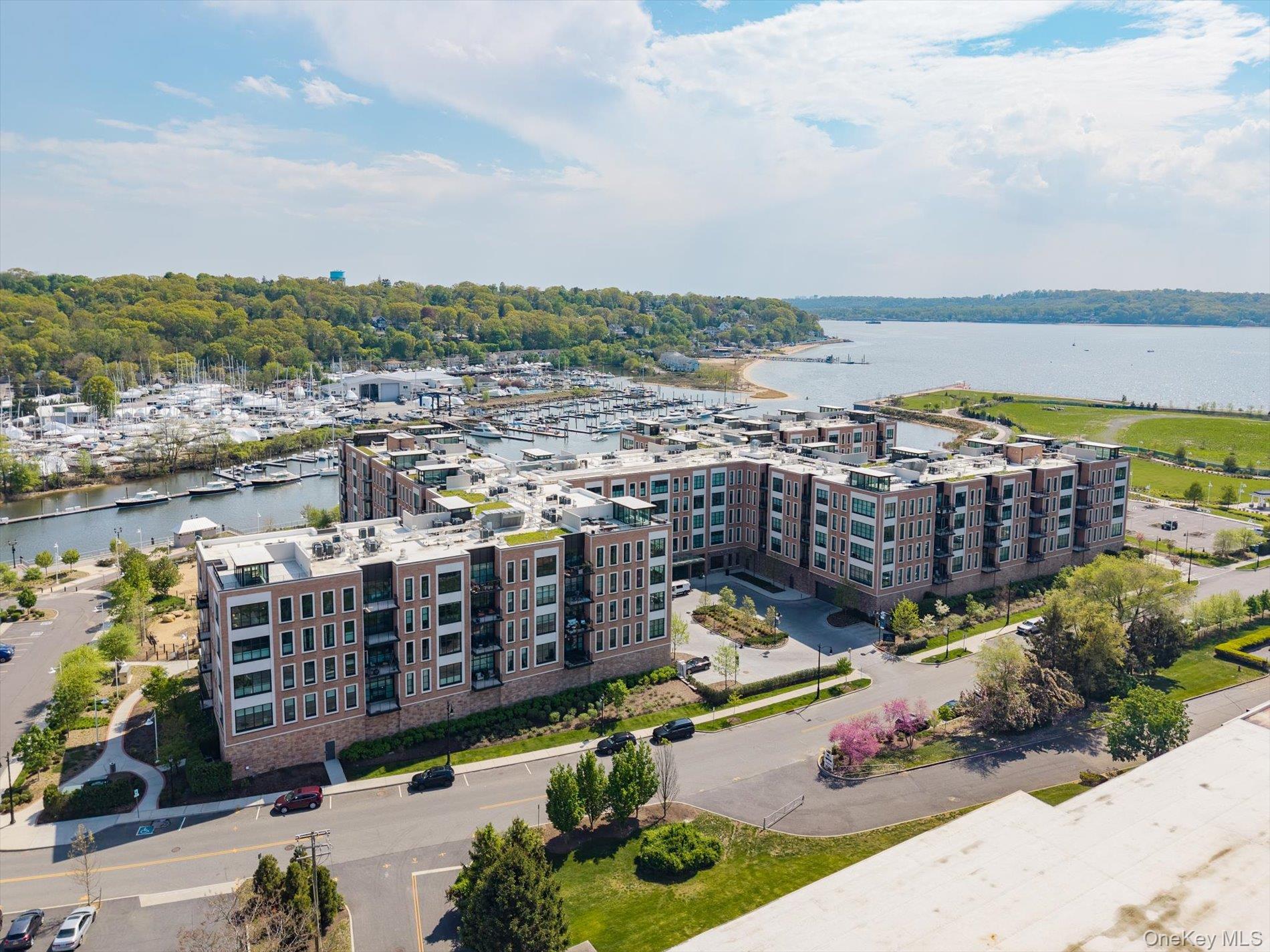 100 Garvies Point Road, Unit 1042 Glen Cove, NY 11542 - Photo 21 of 33 Drone / aerial view of a large body of water and apartment complex