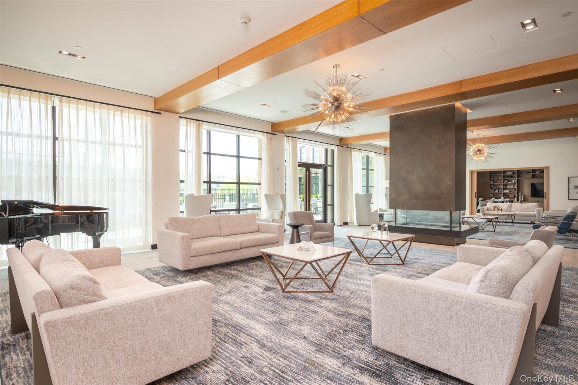 100 Garvies Point Road, Unit 1042 Glen Cove, NY 11542 - Photo 29 of 33 Living room with beam ceiling