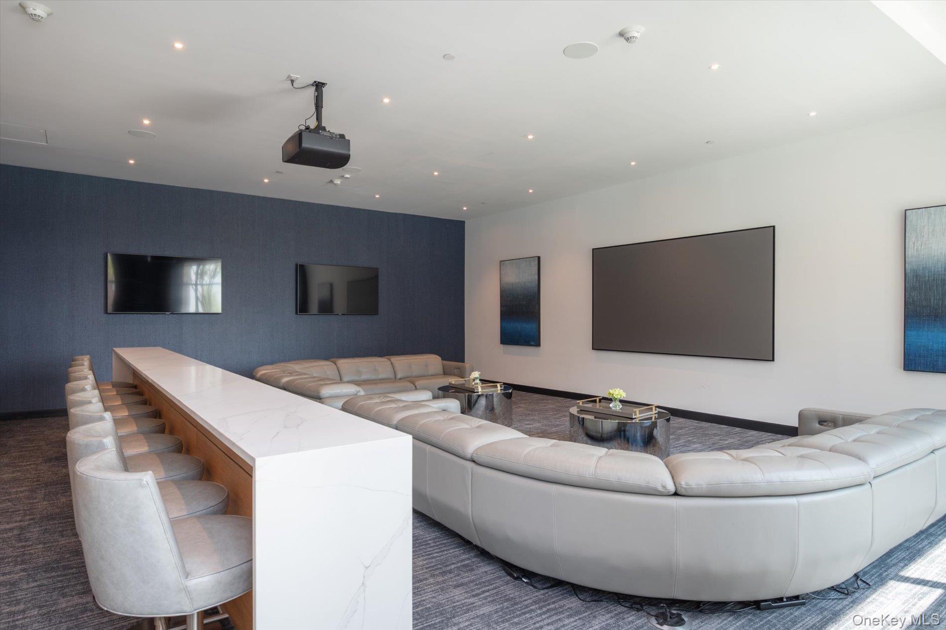 100 Garvies Point Road, Unit 1042 Glen Cove, NY 11542 - Photo 31 of 33 Home theater room with an accent wall, recessed lighting, and baseboards