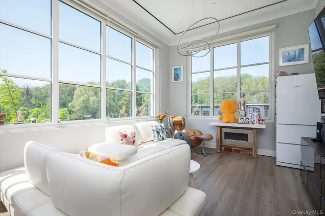 a living room with furniture and large windows
