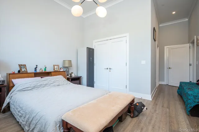 a bed room with a bed and a chandelier