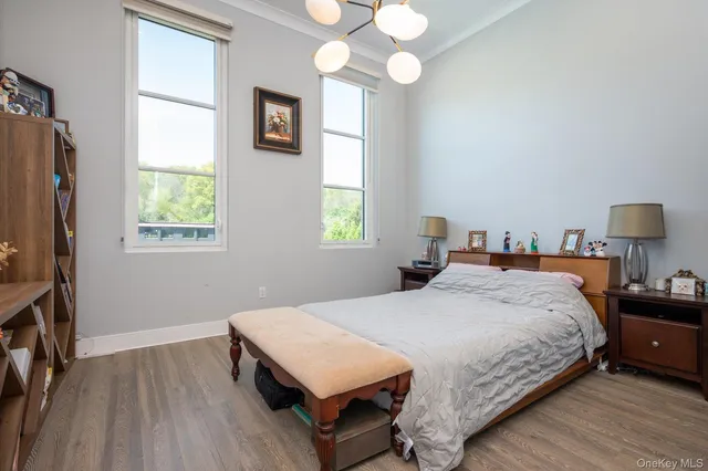 a bedroom with a bed window and a flat screen tv