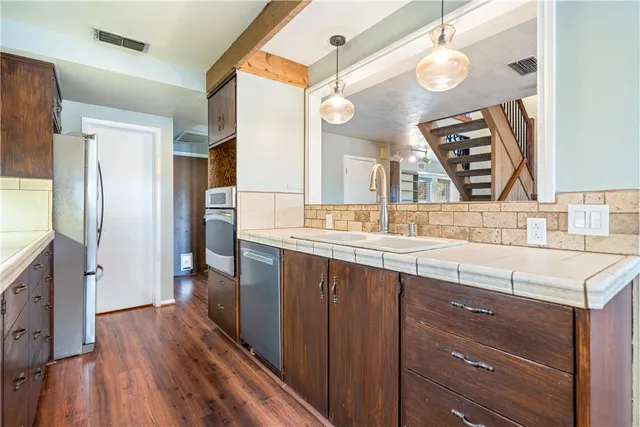 a view of an entryway with wooden floor