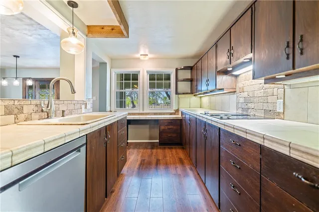 a bedroom with a large bed and a chandelier fan
