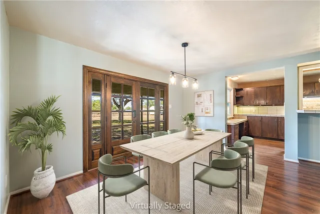 a view of a kitchen with wooden floor and a refrigerator