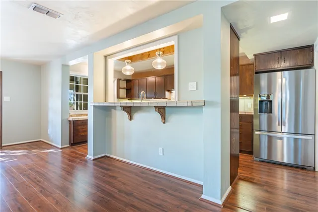 a kitchen with granite countertop wooden cabinets and a sink