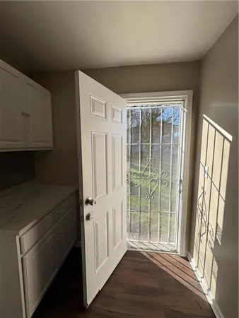 a view of a hallway with wooden floor and staircase