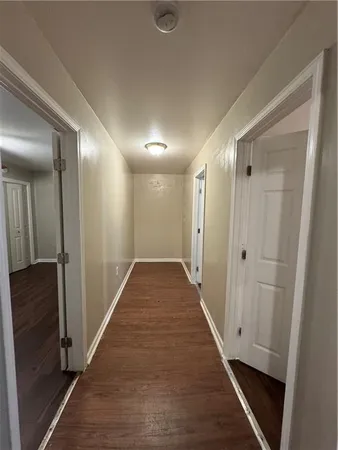 a view of hallway with wooden floor