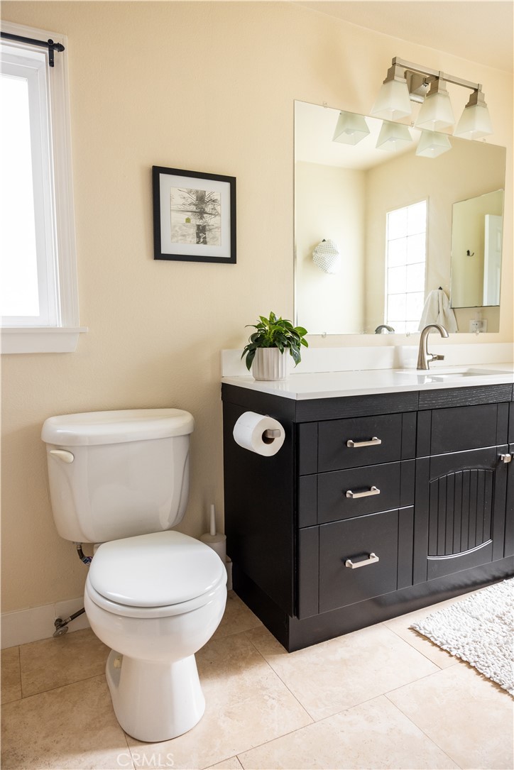 26251 Brookhollow Lake Forest, CA 92630 - Photo 15 of 27 a bathroom with a toilet sink vanity granite and mirror