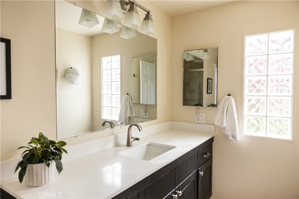 26251 Brookhollow Lake Forest, CA 92630 - Photo 16 of 27 a bathroom with a double vanity sink mirror and vanity